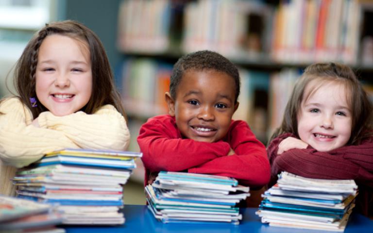 Children sitting with books